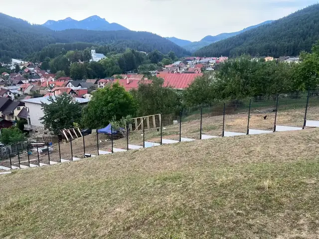 Výhľad na Ružomberok a okolité hory s rozostavaným plotom v popredí